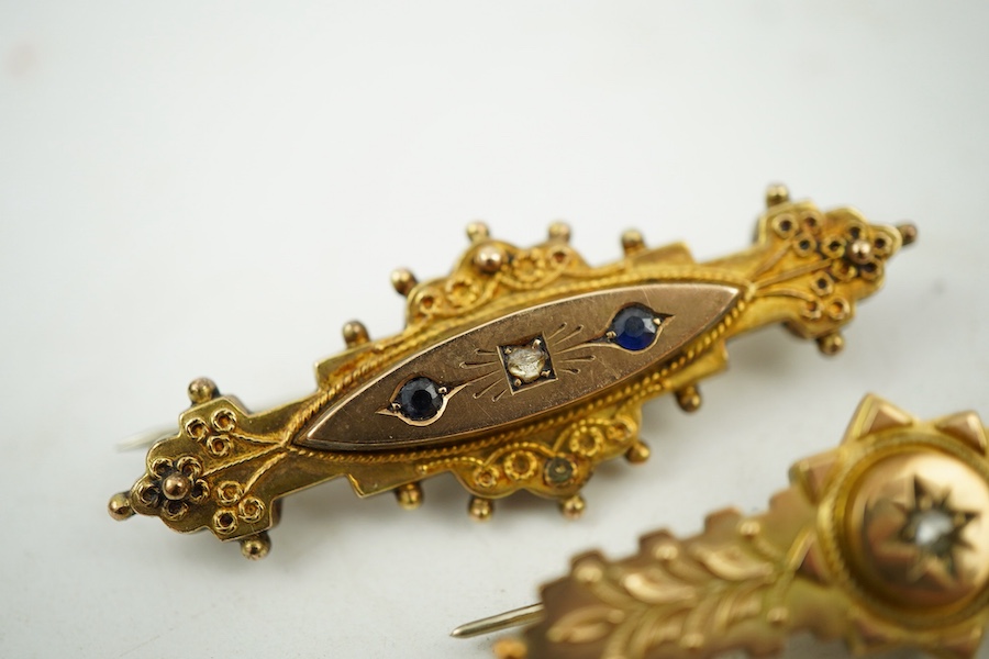 A collection of jewels, comprising: two cross pendants; a heart-shaped locket pendant; a circular locket pendant engraved with a sunflower; a pendant set with a sapphire; a diamond panel brooch; and a sapphire and diamon